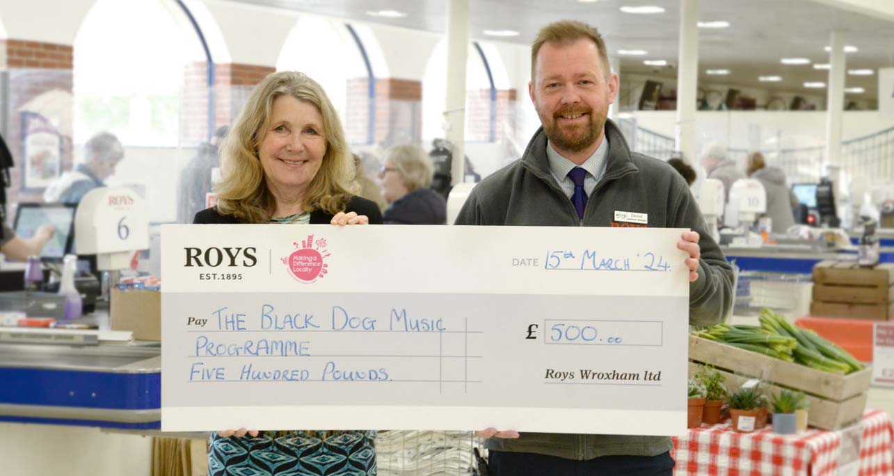 Roys Food Hall Assistant Manager Presenting a cheque to Sarah Gilbert from The Black Dog Music Project