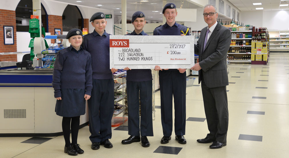Wroxham Store Controller Chris Green presenting a cheques of £200 to member of Broadland 222 squadron Air Training Corp